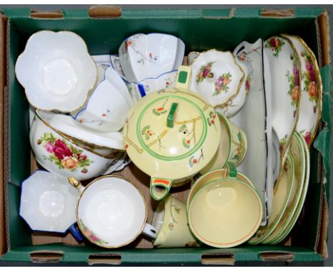 AN ART DECO STAFFORDSHIRE CONICAL EARTHENWARE TEA SET FOR TWO, DECORATED WITH COTTAGE AND HOLLYHOCK, TEAPOT AND COVER 12.5CM 