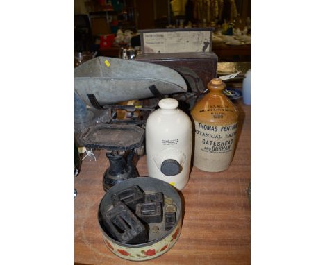 A cast iron kitchen balance and weights; a stoneware hot water bottle; a stoneware flagon inscribed 'Thomas Fentiman Botanica