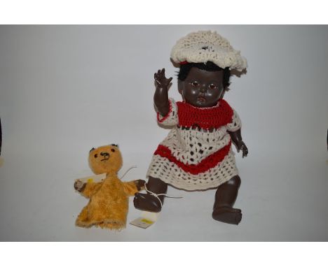 A rosebud coloured baby doll with rolling eyes and open mouth, wearing a knitted dress; together with a very play worn Sooty 