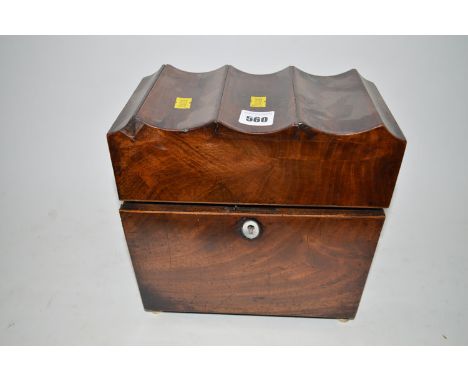 An 18th Century mahogany tea caddy with mother-of-pearl escutcheon, later tin lined interior, raised on bun bone feet.