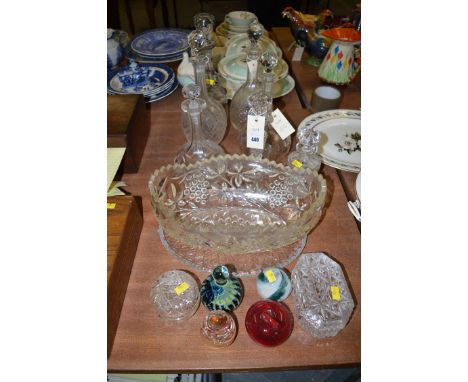 A collection of six cut glass decanters; candlestick; paperweights; etc.