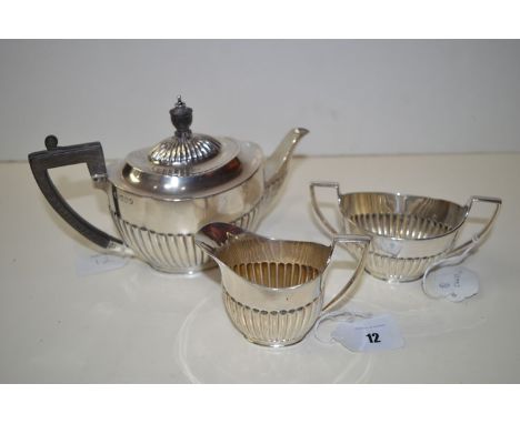 A three-piece silver tea service, by W.S.C.S., London 1902, of oval half fluted form, 19oz gross.
