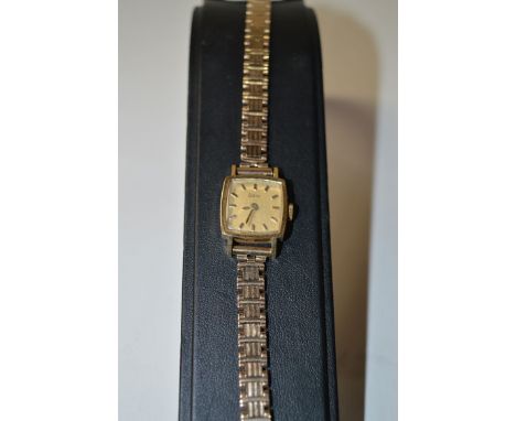 An 18ct. gold cased Zodiac cocktail watch, with baton gilt dial Swiss movement, on a 9ct. yellow gold link pattern bracelet.