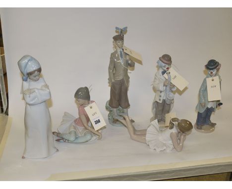 A Lladro ballerina; a Nao ballerina; a Lladro model of a young boy in a night dress and cap; a Lladro figure of a golfer; and