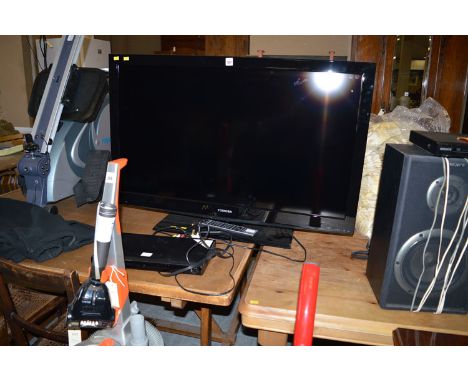 A large Toshiba flat screen TV with remote control; and an LG DVD/CD player.