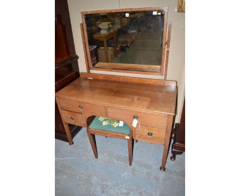 An oak kneehole dressing table with rectangular bevelled mirror and four drawers, raised on square legs; and a matching recta