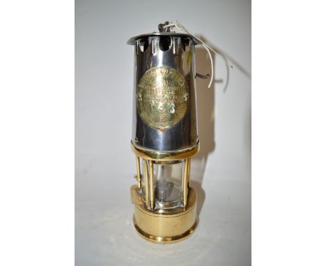A Protector Lamp & Lighting Co. Type SL Miner's lamp with polished steel bonnet and brass