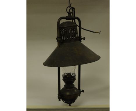 Six industrial oil lamp style hanging lights fitted for electricity, with chimneys and chains.