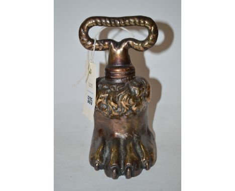 A 19th Century brass door step in the form of a lion's paw with loop handle.