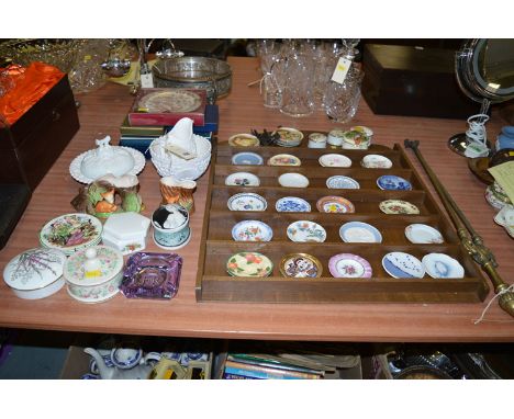 A collection of miniature plates/trinket dishes on a wall mounted display rack; miscellaneous decorative china; moulded glass