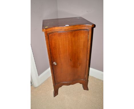 A mahogany bedside cabinet with serpentine front, fitted a single door enclosing an interior with one shelf, raised on bracke