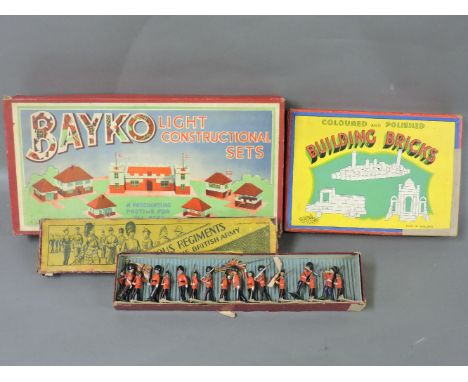 Britain's Bedfordshire and Hertfordshire Regiment lead soldiers, No 1558, a Bayko light construction set, and a box of colour
