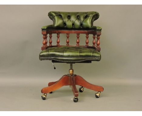 A green leather button back strung mahogany desk chair