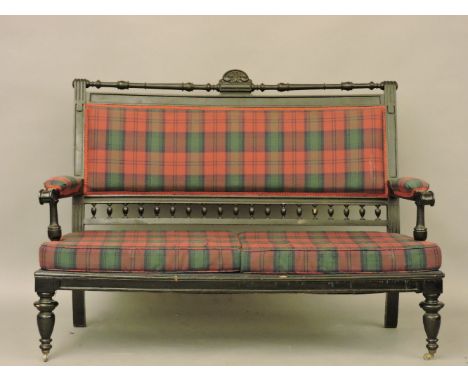 A Victorian settee, upholstered in tartan