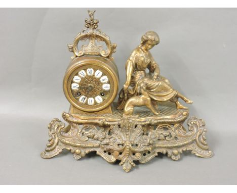 A 19th century gilt brass mantel clock, modelled with a lady and dog, with enamel numbering