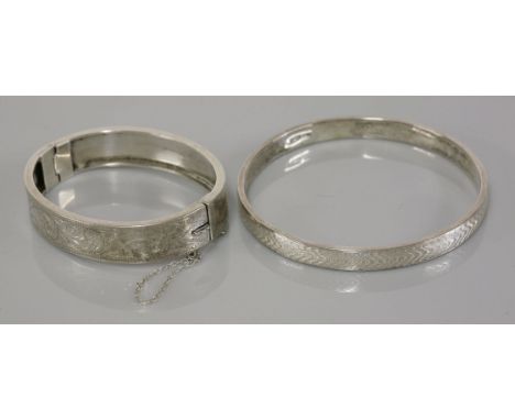 A sterling silver engine turned bangle, by Charles Horner, Chester 1924, and a sterling silver hinged bangle