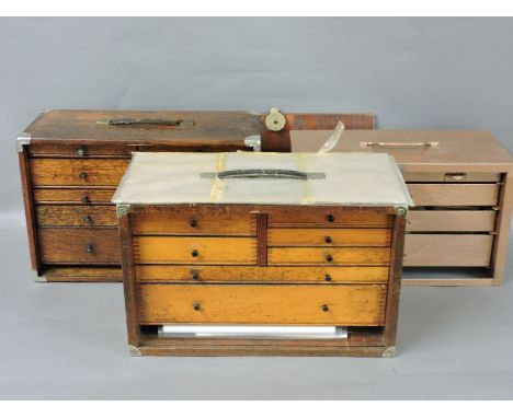 Three tool chests, including two wooden examples containing a quantity of stationery and tools