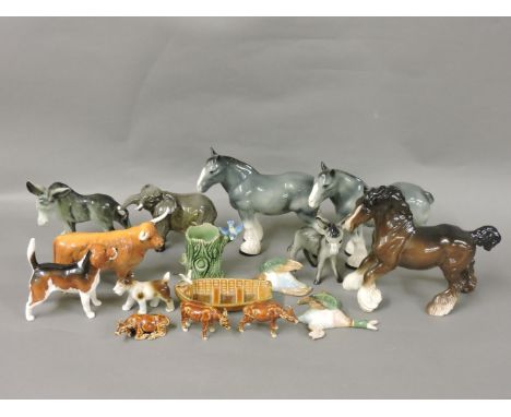 A quantity of Beswick figurines, Wade and other porcelain figures, to include a Highland cow, an elephant, etc