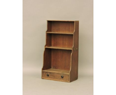 A Regency period small waterfall mahogany book shelf, with single drawer beneath