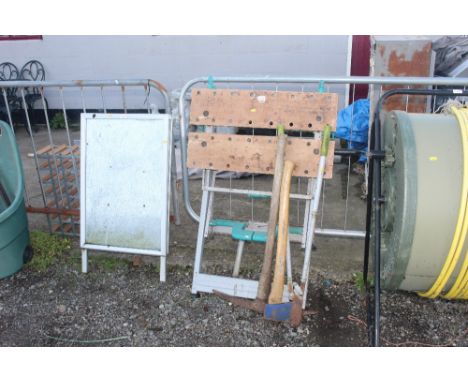 A builders folding workmate, a pick axe, axe and set of loppers