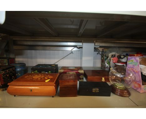 A collection of wooden trinket boxes and a glass model of an airplane 