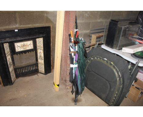 A bundle of walking sticks, umbrellas and a camera tripod