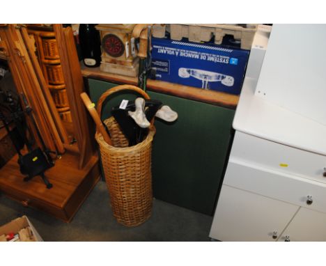A wicker stick stand, contents of sticks and a folding card table