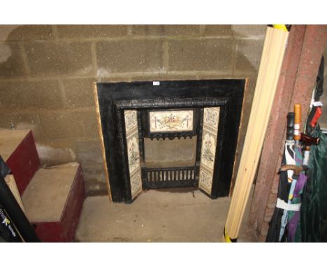 A Victorian cast iron fire place with tile insert