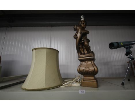 A cherub decorated table lamp and shade