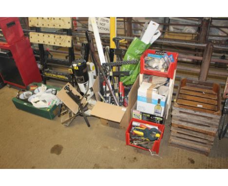 A box containing various tools including builders level, large ruler, right angle measures, adjustable spanners etc