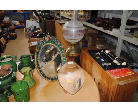A carved wooden jewellery stand; oil lamp; a Barbola type easel mirror