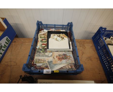 A box containing vintage postcards and ephemera 