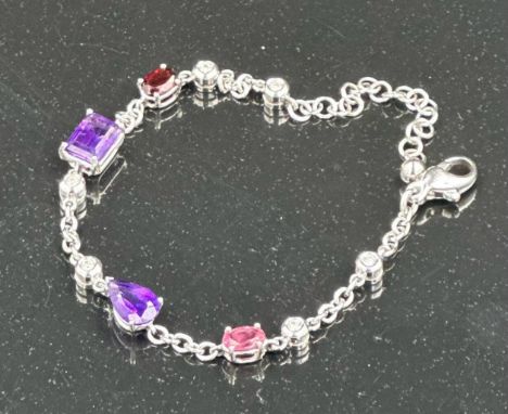 An 18ct white gold bracelet with topaz, amethyst and ruby interspersed by six small diamonds, total length 19cm (Approximate 