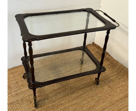 A vintage serving table with brass wheels possibly Italian (H68cm W80cm)