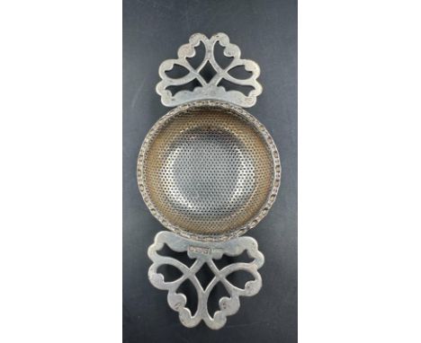 A hallmarked silver tea strainer, Birmingham 1989 by R E Porter