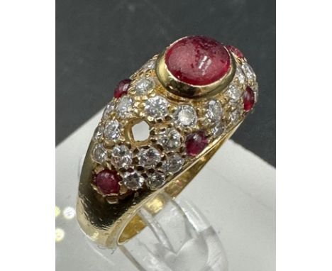 An 18ct gold, marked 750, ruby and pave diamond ring, marked Cartier to the band. With a single missing red stone AF Approxim