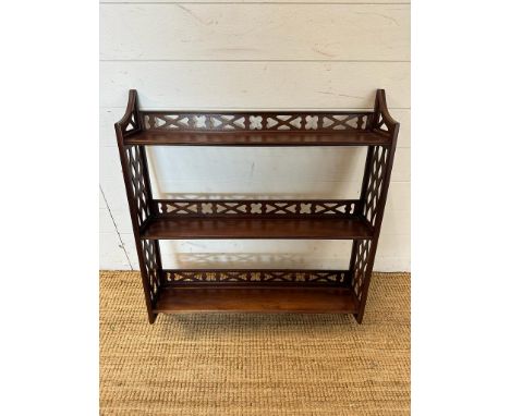 A mahogany three shelf wall hanging bookcase with piece sides and back rail. 