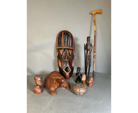 A selection of tribal treen items to include busts, a mask and a decorative axe 