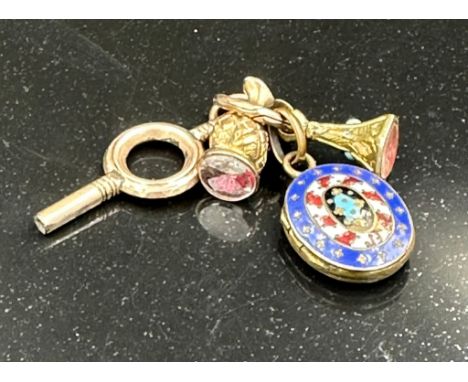 An 18ct gold pocket watch AF along with key, two stamps and and enamel locket