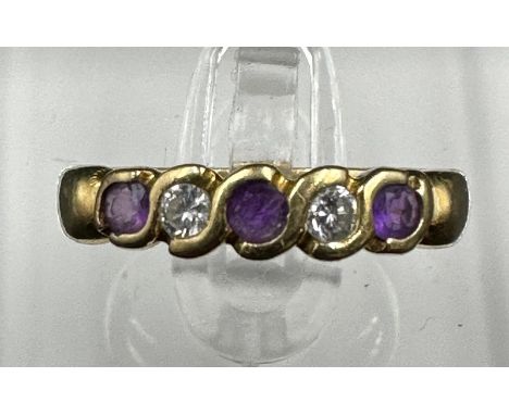 An 18ct gold amethyst and cubic, zircona half hoop eternity ring Size K