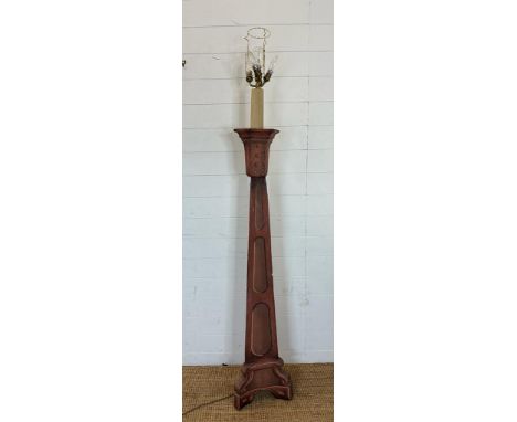 A wooden floor standing prop lamp with tapering base