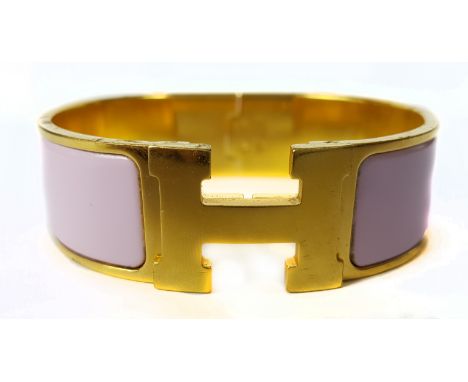 Vintage Costume Jewellery - A Hermes clic clac pink enamel bracelet on yellow metal finish, stamped marks, 6.5cm diam