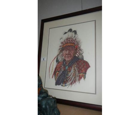 A framed and glazed tapestry of an American Indian chief.