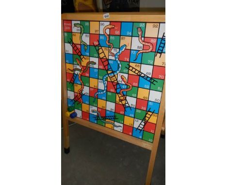 A snakes and ladders easel.