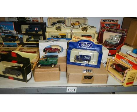 A shelf of Lledo die cast models.