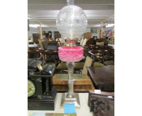 A silver plate Corinthian column oil lamp with shade and chimney.