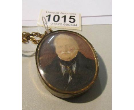 A miniature watercolour portrait of an elderly gentleman mounted in a pendant.