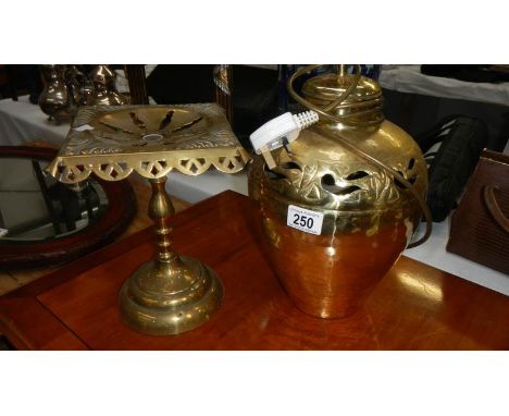 A Victorian brass trivet and a brass lamp base.