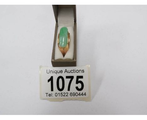 A jade cabachon ring, 14ct gold, size M (bought in the USA).