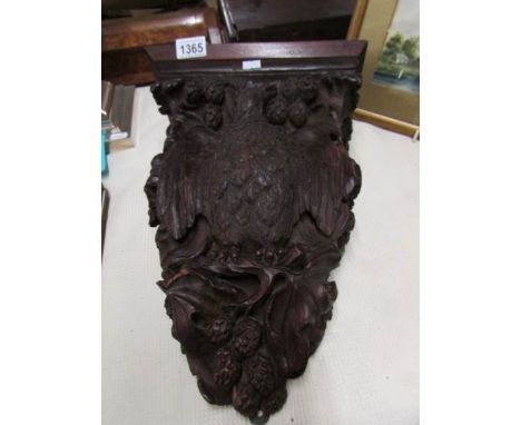 A carved wood eagle wall shelf.